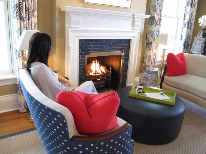 A guest at the Rowland Inn overlooking Lake Cayuga relaxes in front of the fireplace in one of the sitting rooms. (Pamela O'Meara/Review staff)
