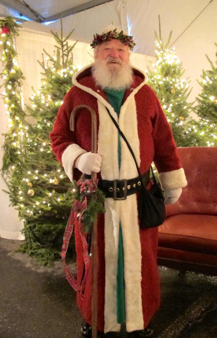 St. Nicholas dressed in red velvet greets guests at the entrance to the Old World Christmas Market.